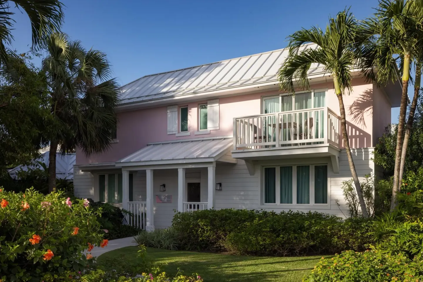 Villa exterior with balcony and garden landscaping at Sandals Royal Bahamian.
