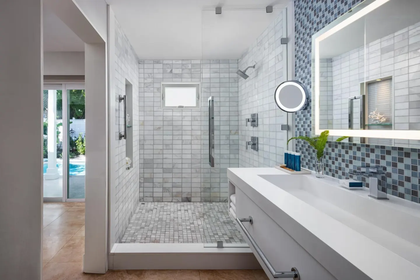Villa bathroom with walk-in shower and double vanity at Sandals Royal Bahamian.