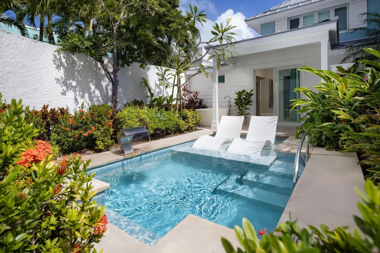 Private pool patio with in-water loungers outside a villa at Sandals Royal Bahamian.