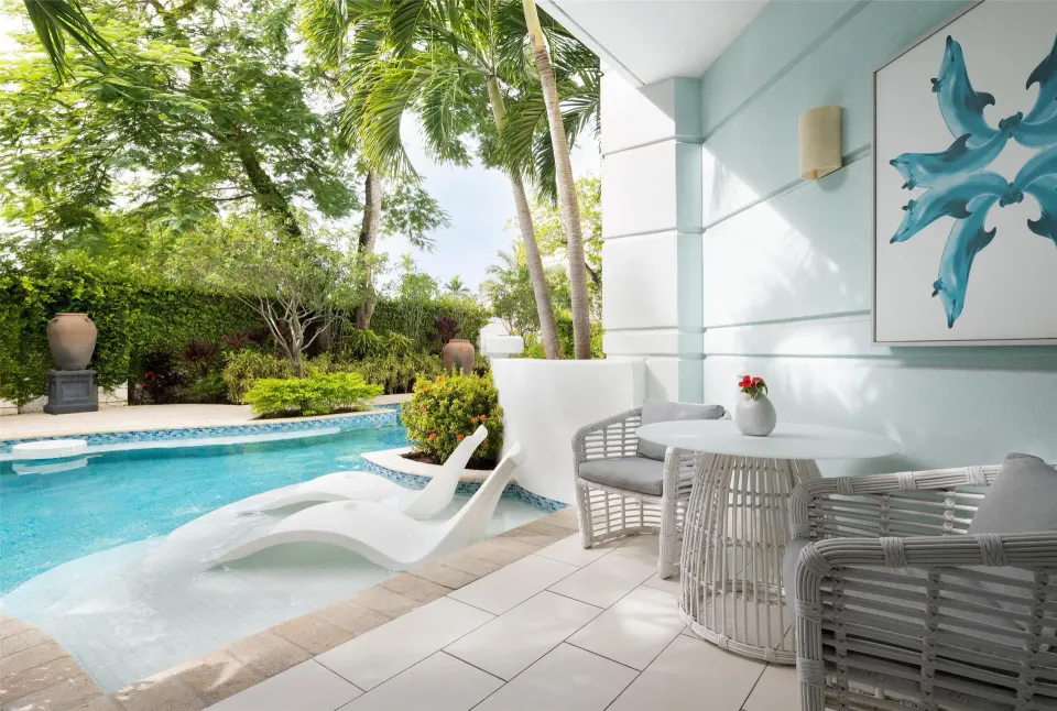 Private swim-up terrace with loungers and seating at Sandals Royal Bahamian.