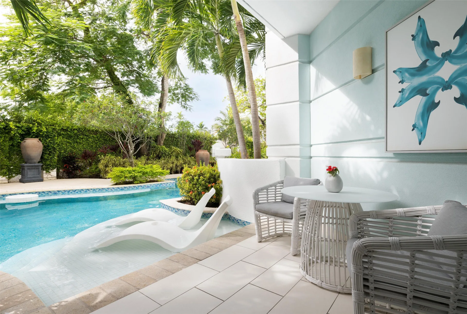 Private swim-up terrace with loungers and seating at Sandals Royal Bahamian.