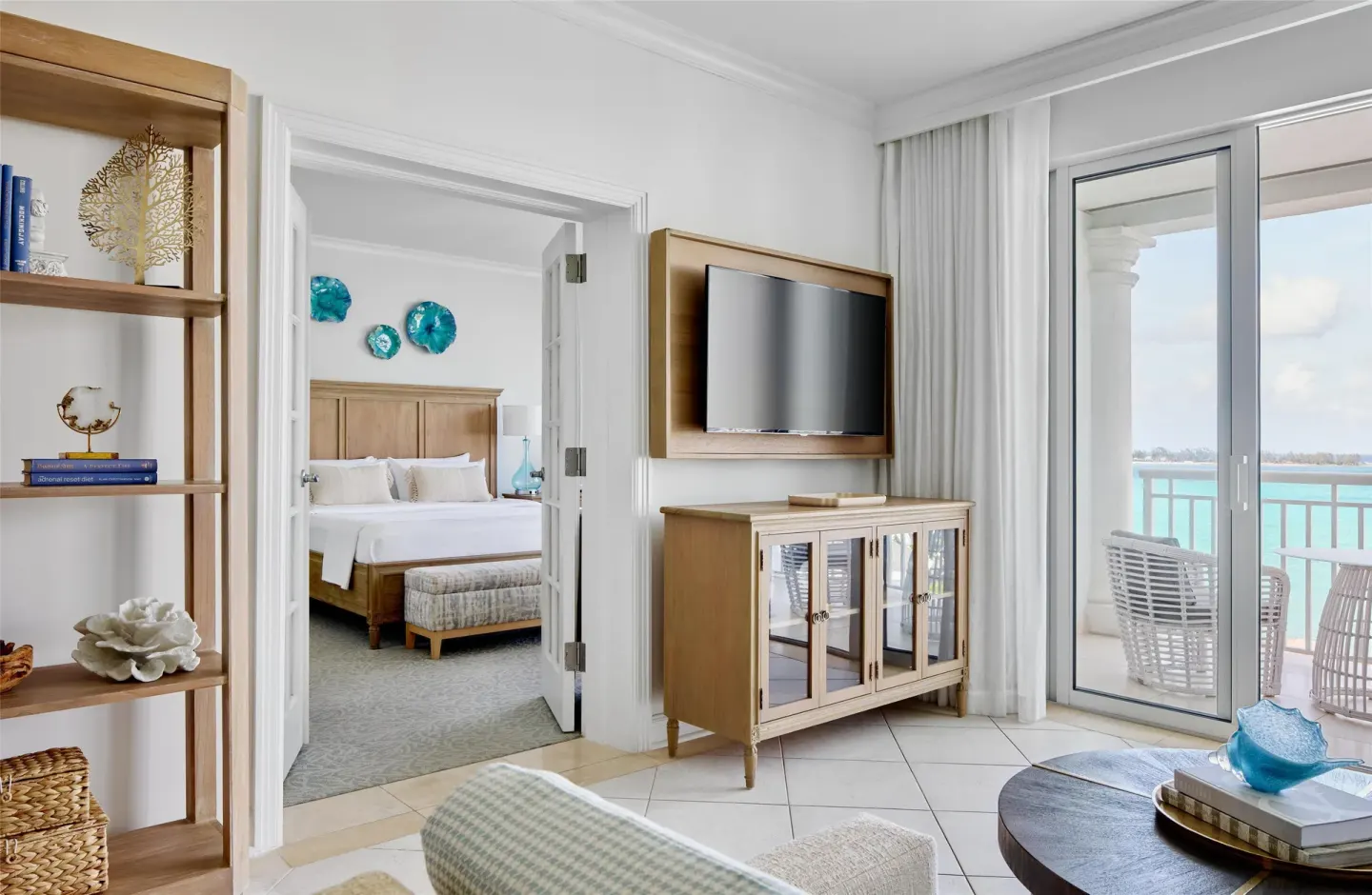 Living room and bedroom of West Bay Honeymoon Oceanview Suite at Sandals Royal Bahamian.