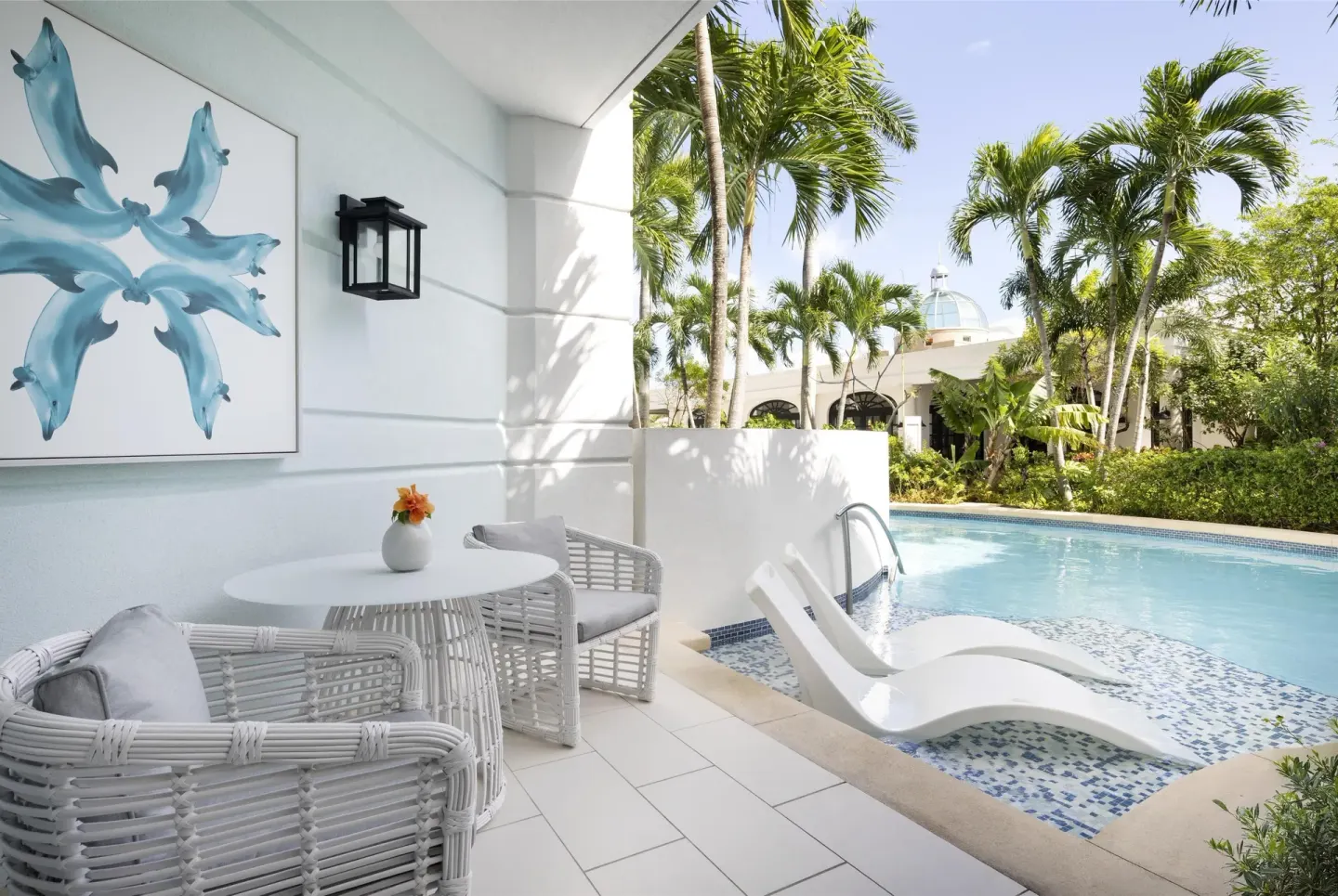 Private swim-up patio with pool loungers at Sandals Royal Bahamian.