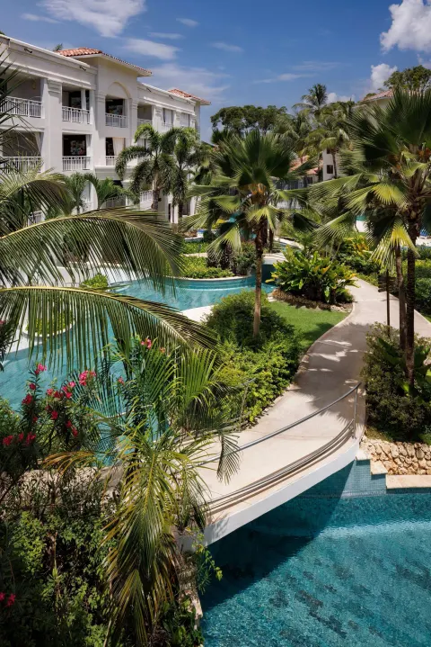 Palm-lined lagoon pool and white guest buildings at Sandals Royal Barbados.