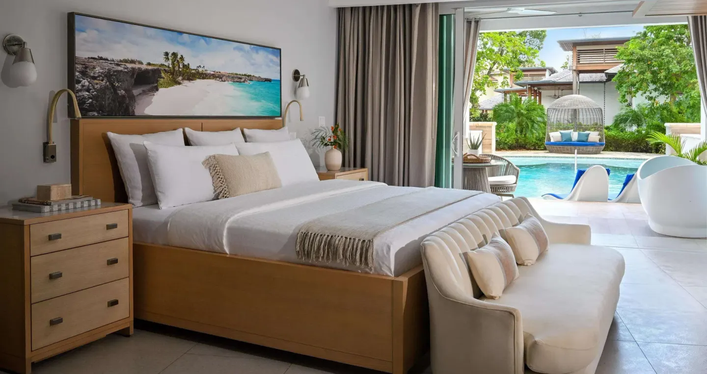 King bed suite with poolside terrace and outdoor tub at Sandals Royal Barbados.