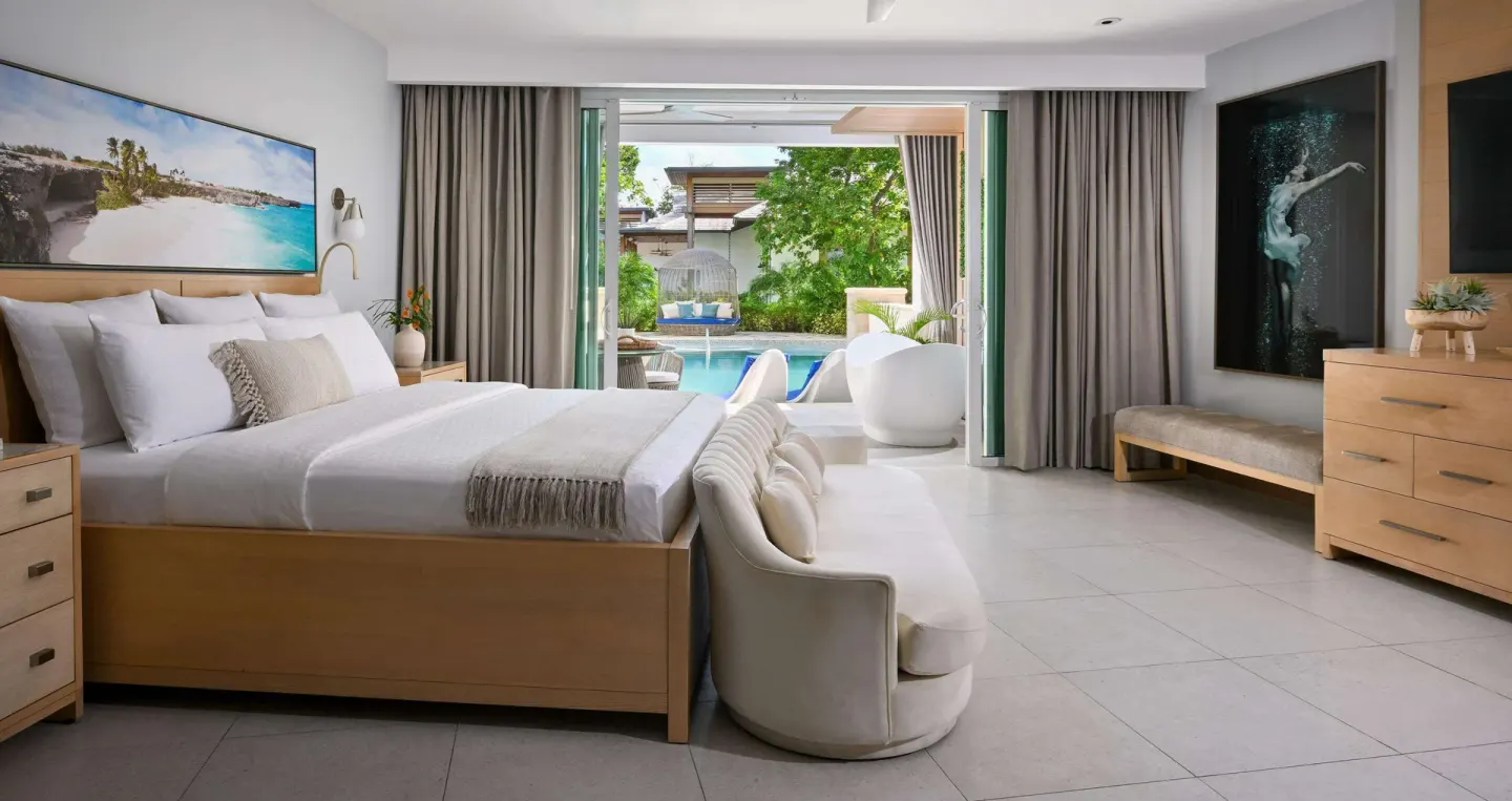 Swim-up guest room with king bed and patio pool access at Sandals Royal Barbados.