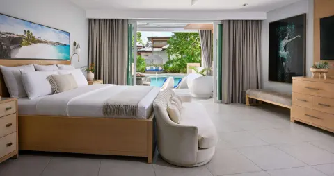 Swim-up guest room with king bed and patio pool access at Sandals Royal Barbados.