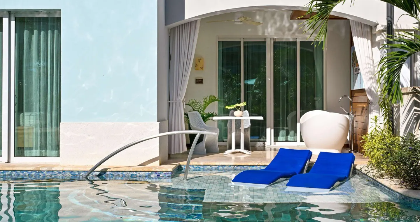Swim-up patio with blue loungers and soaking tub at Sandals Royal Barbados.