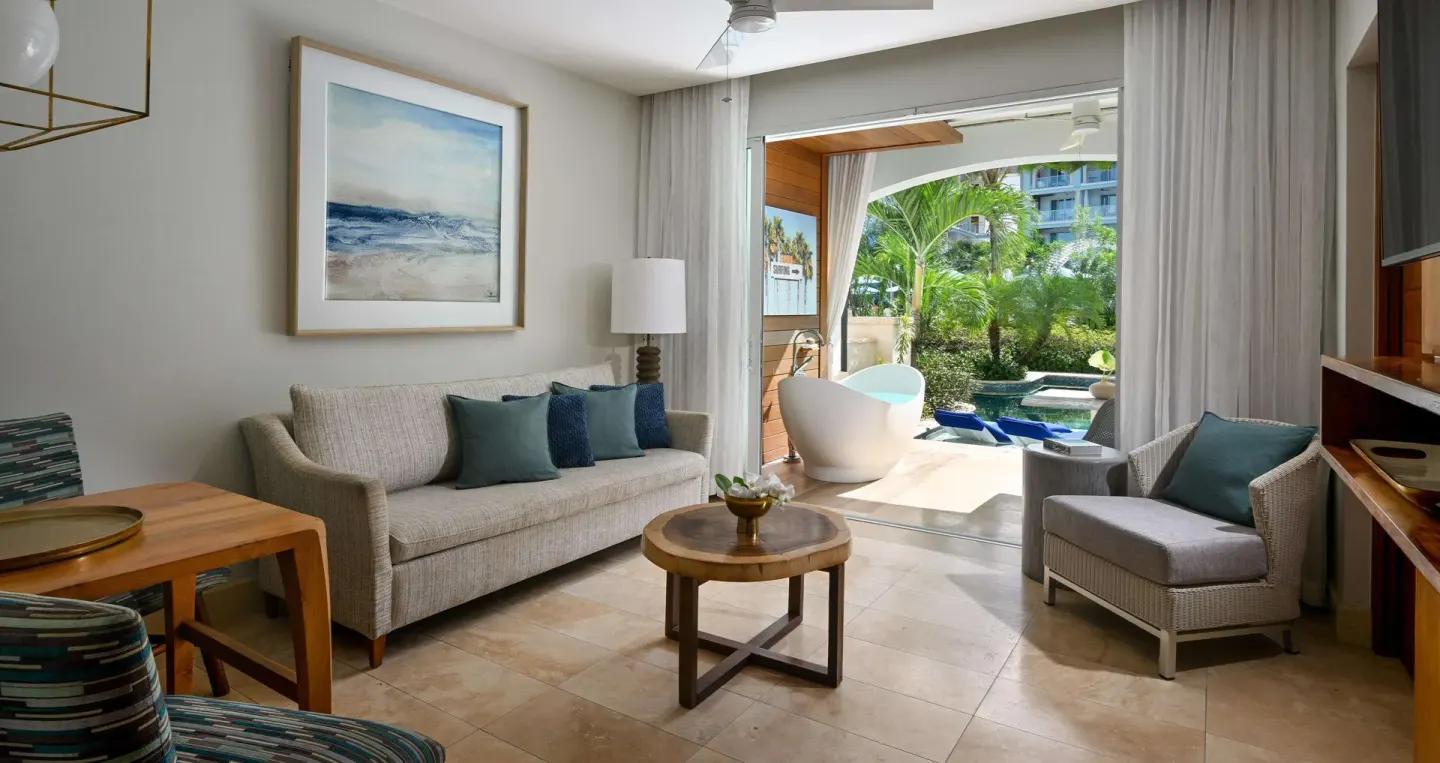 Suite sitting area opening to a swim-up patio at Sandals Royal Barbados.