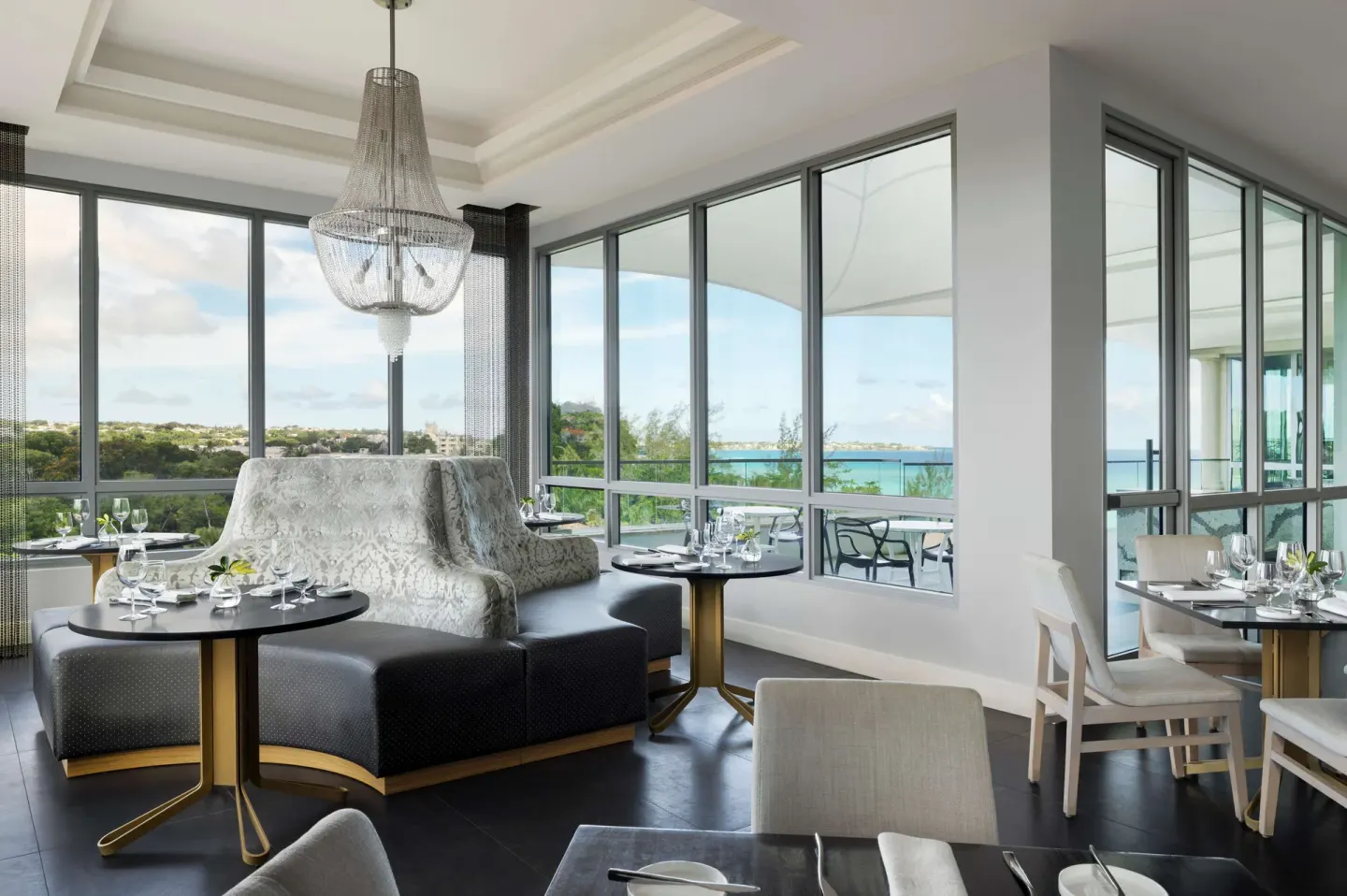 Corner dining room with ocean-facing windows at Sandals Royal Barbados.
