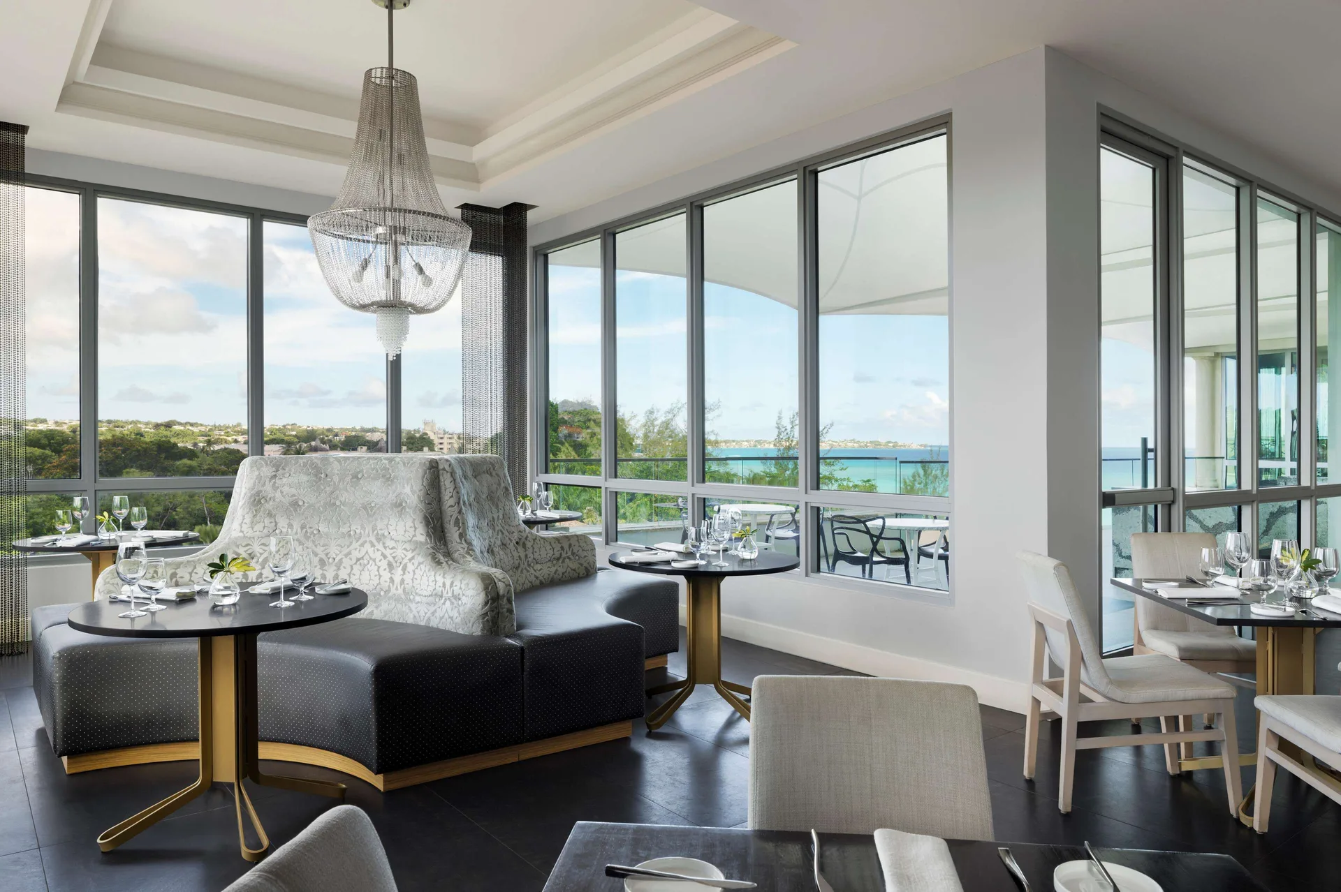 Corner dining room with ocean-facing windows at Sandals Royal Barbados.