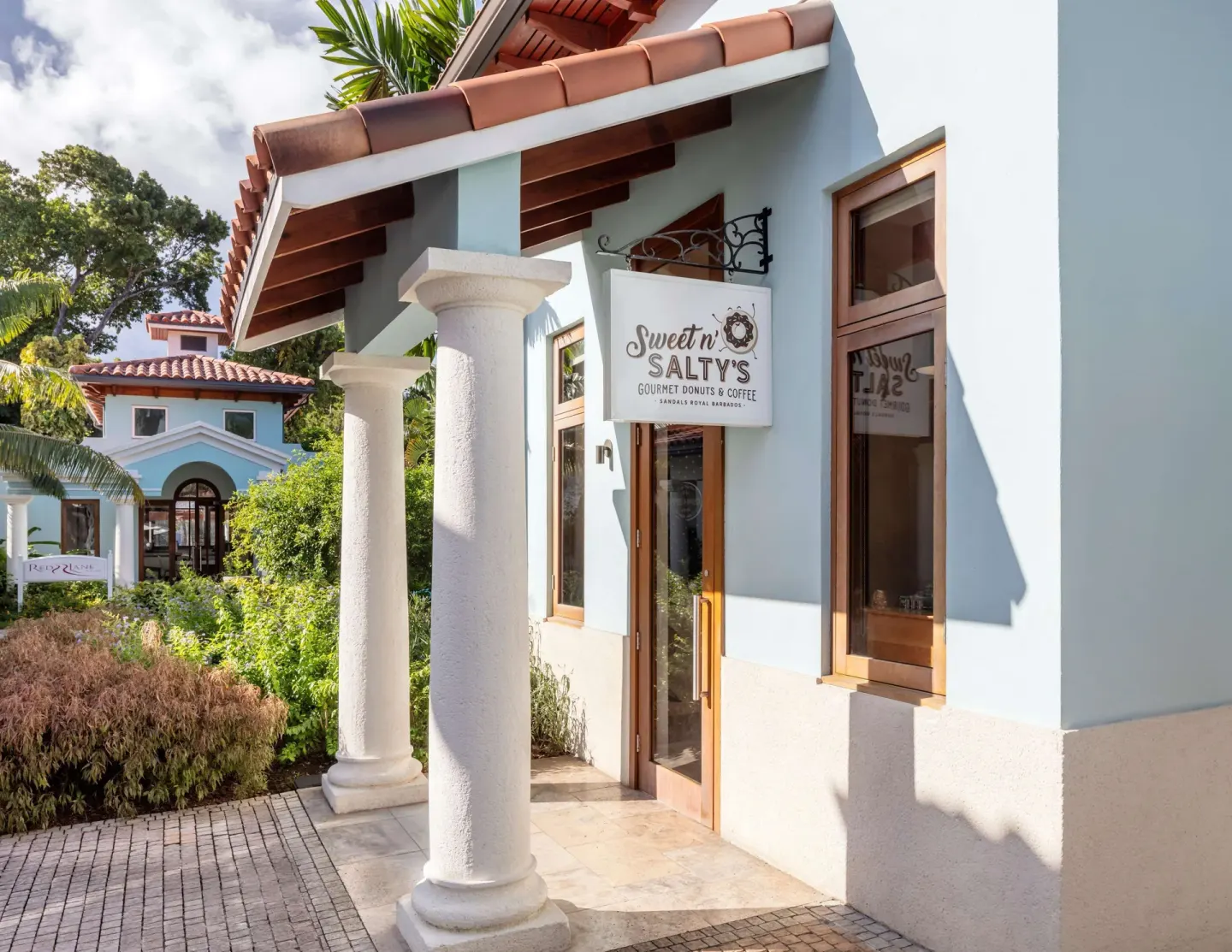 Sweet n' Salty's cafe entrance with white columns at Sandals Royal Barbados.