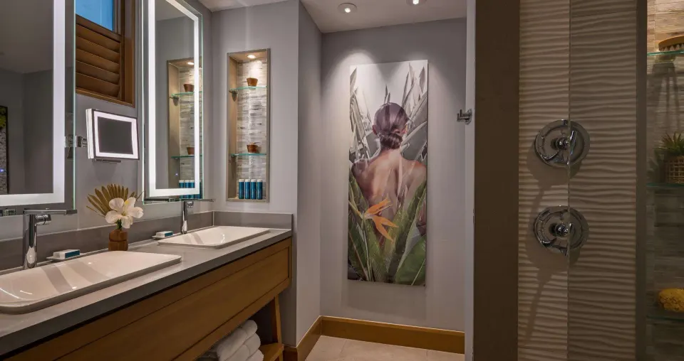 Club Suite bathroom at Sandals Royal Barbados with double vanity, shower, and tropical artwork.