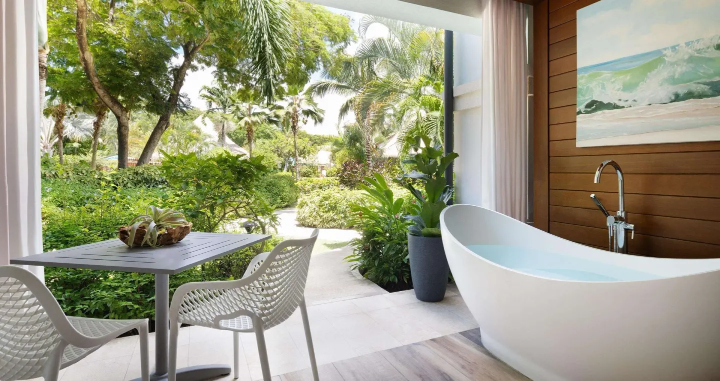 Club suite patio with soaking tub and garden seating at Sandals Royal Barbados.