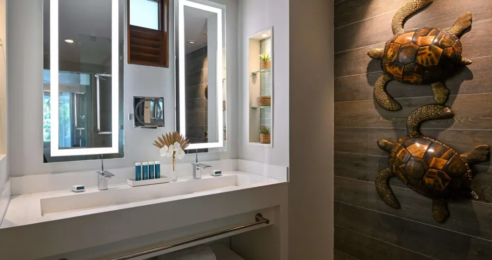 Club Suite bathroom vanity with turtle wall art at Sandals Royal Barbados.