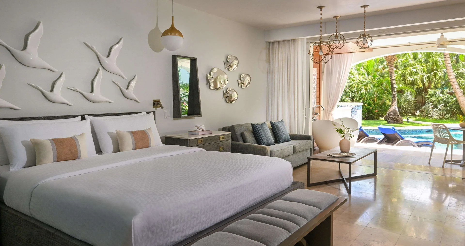 Club Suite bedroom with king bed and pool patio at Sandals Royal Barbados.