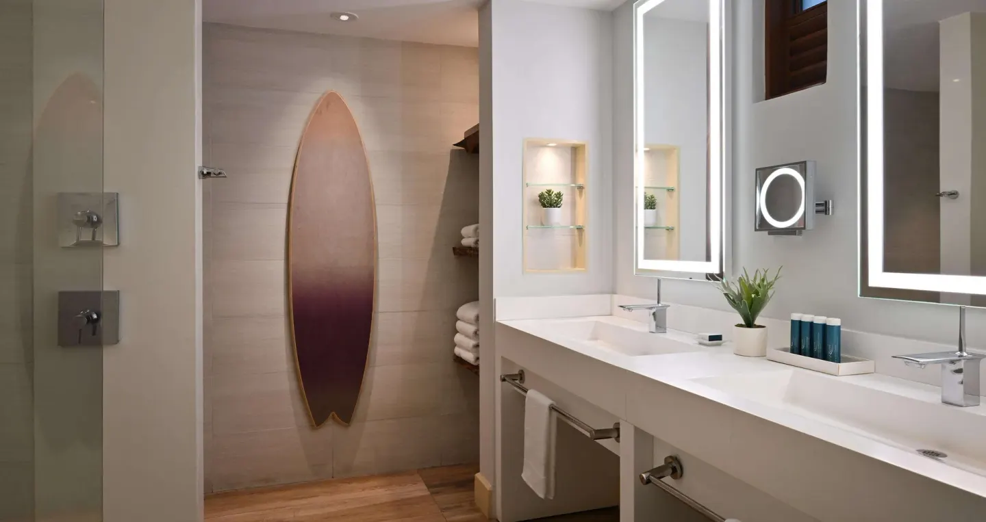 Double vanity bathroom with walk-in shower in a suite at Sandals Royal Barbados.