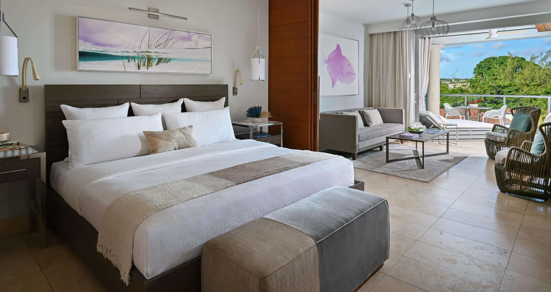 King bedroom and sitting area in a Royal Penthouse Ocean View suite at Sandals Royal Barbados.