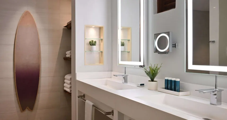 Royal Suite bathroom with double vanity and illuminated mirrors at Sandals Royal Barbados.