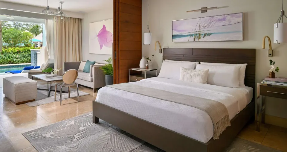 Royal Suite garden view bedroom with king bed and swim-up patio at Sandals Royal Barbados.