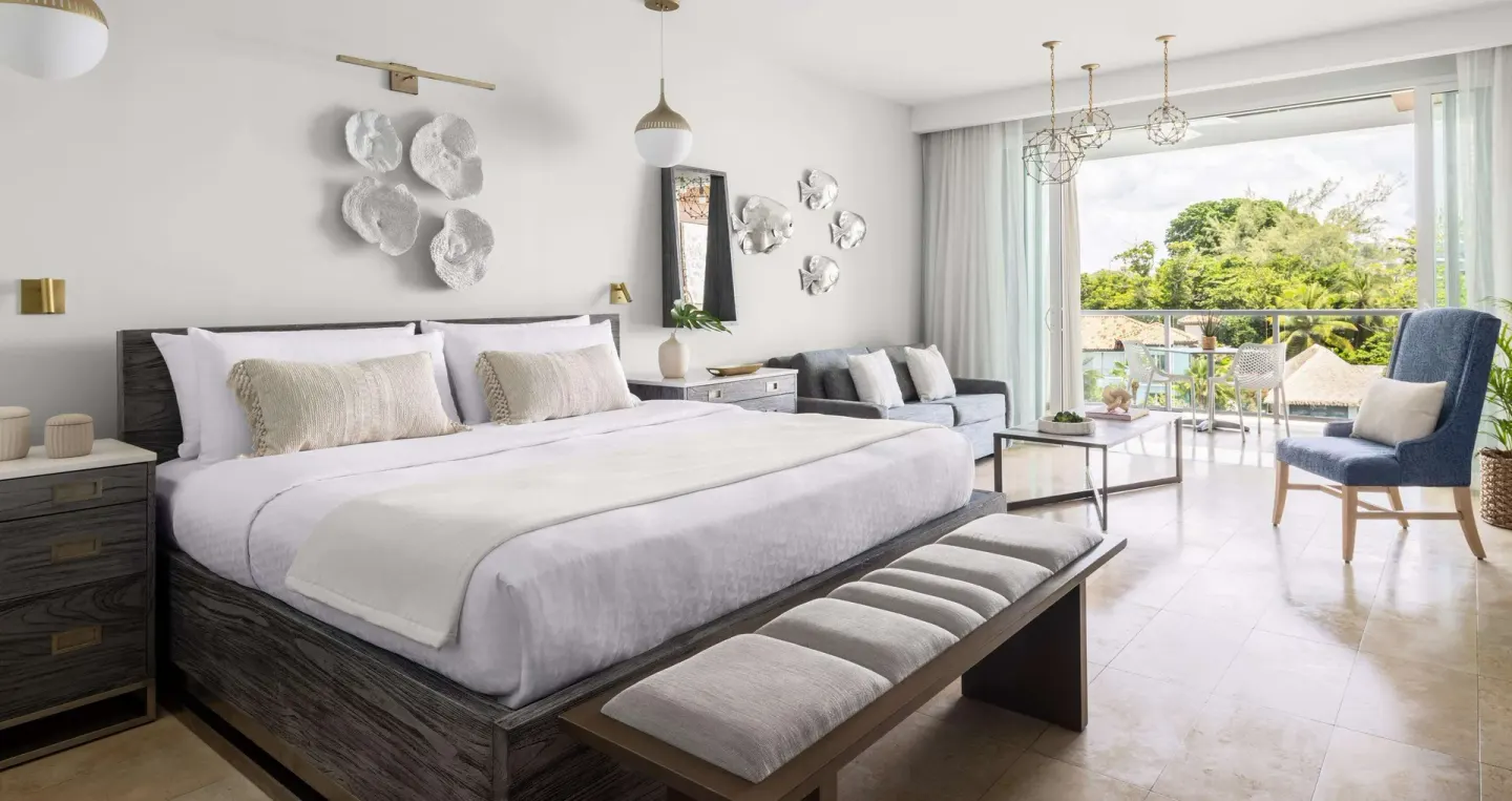 Royal Suite king bed and balcony seating at Sandals Royal Barbados.