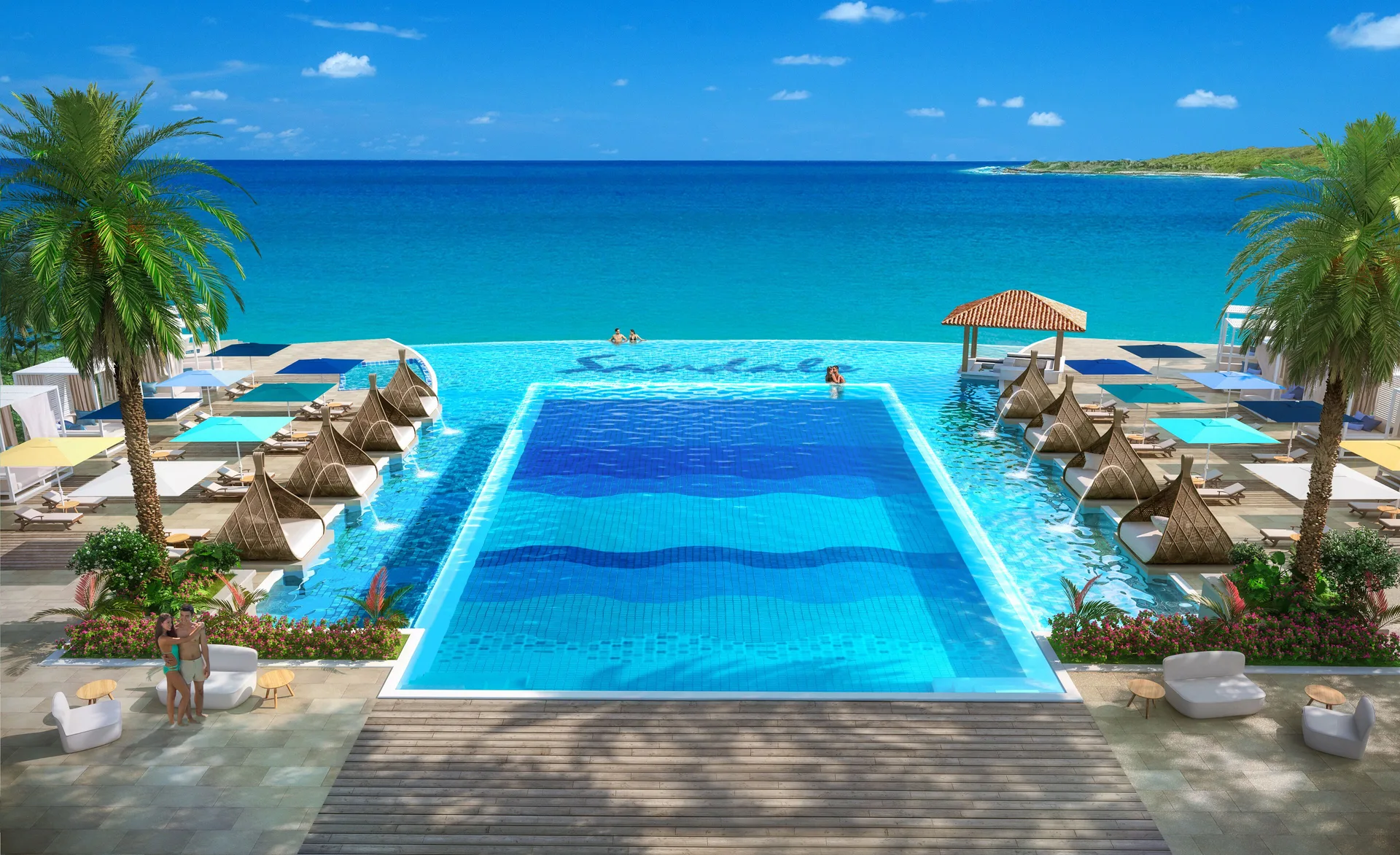 Oceanfront pool with cabanas and turquoise water at Sandals Royal Curacao.