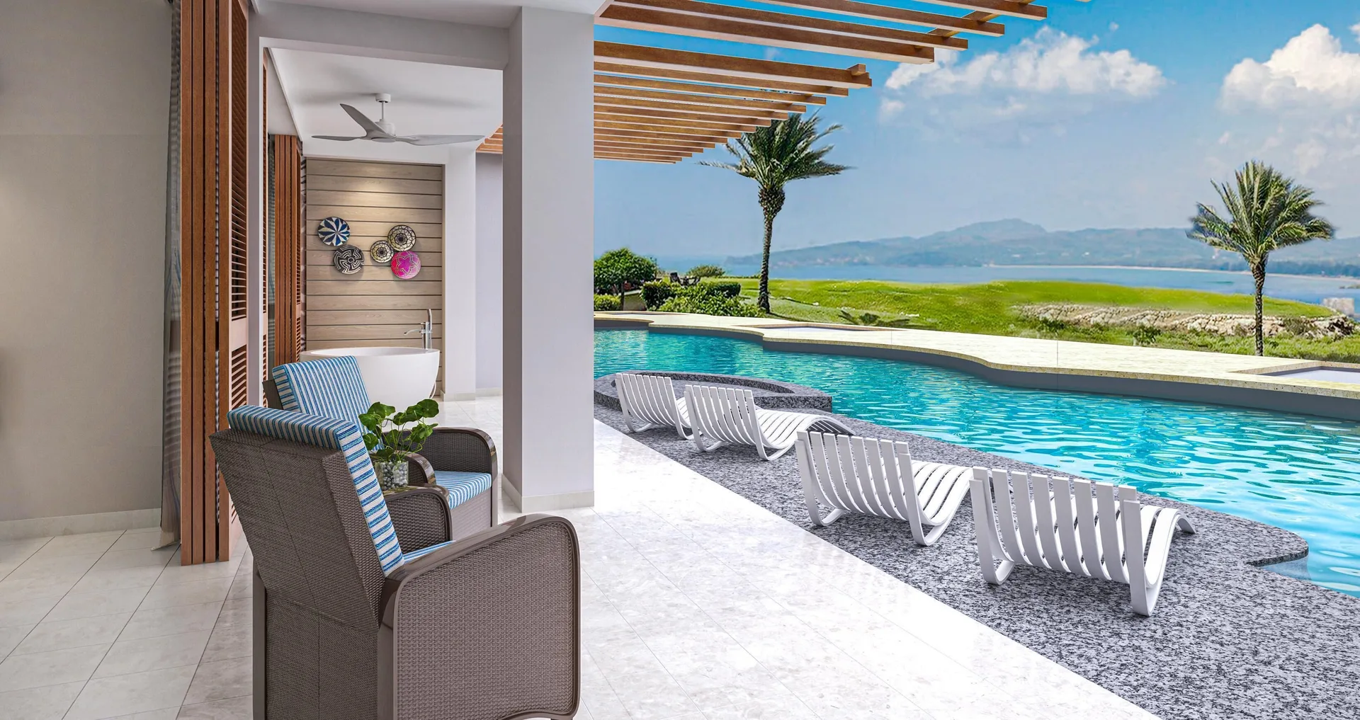 Poolside patio with loungers, chairs, and ocean view at Sandals Royal Curacao.
