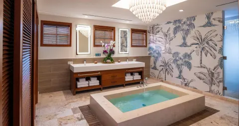 Spacious bathroom with soaking tub and double vanity at Sandals Royal Curacao.