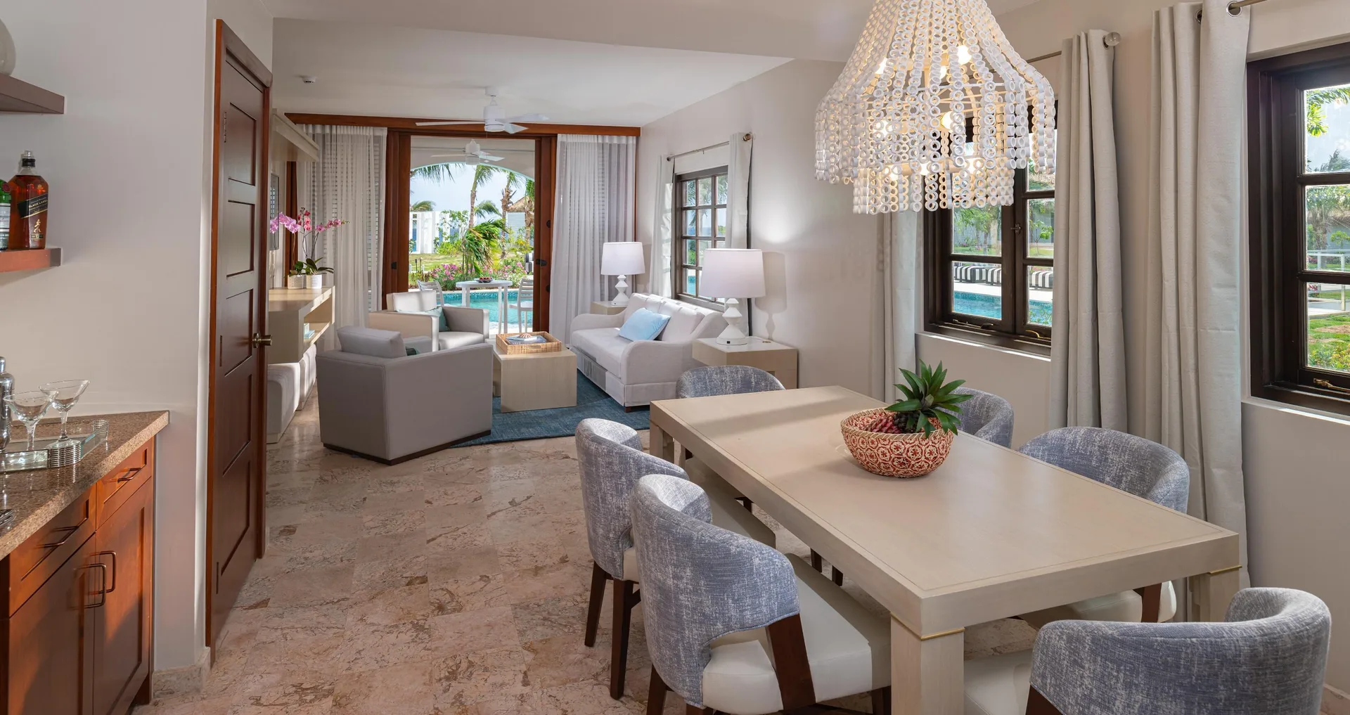 Suite dining and living area with patio doors at Sandals Royal Curacao.