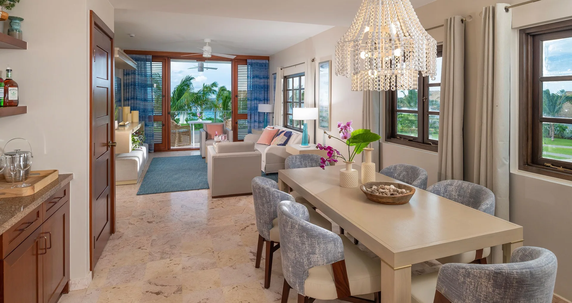 Suite dining and living area with balcony doors at Sandals Royal Curacao.