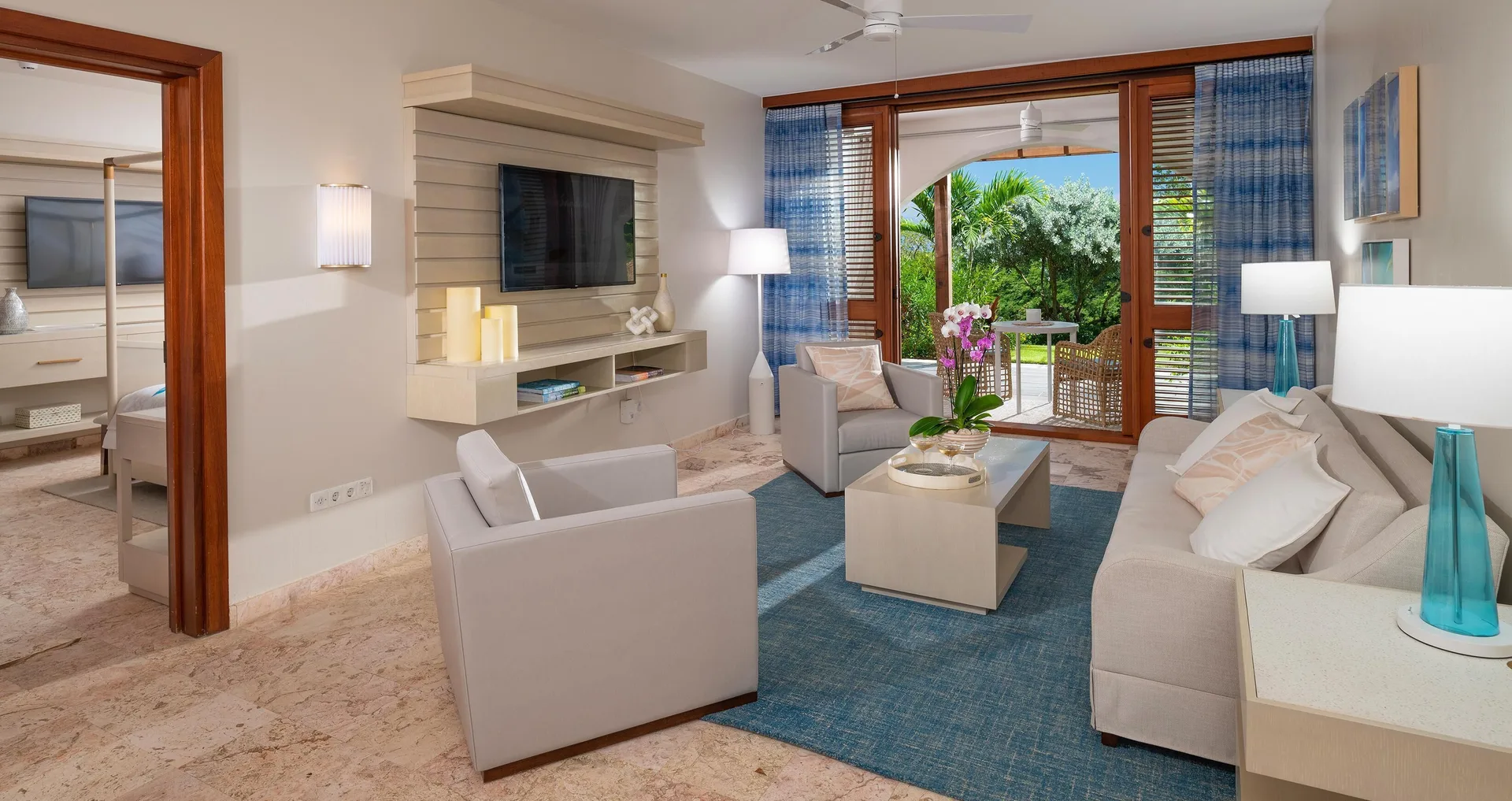 Bright living room with balcony doors in a suite at Sandals Royal Curacao.