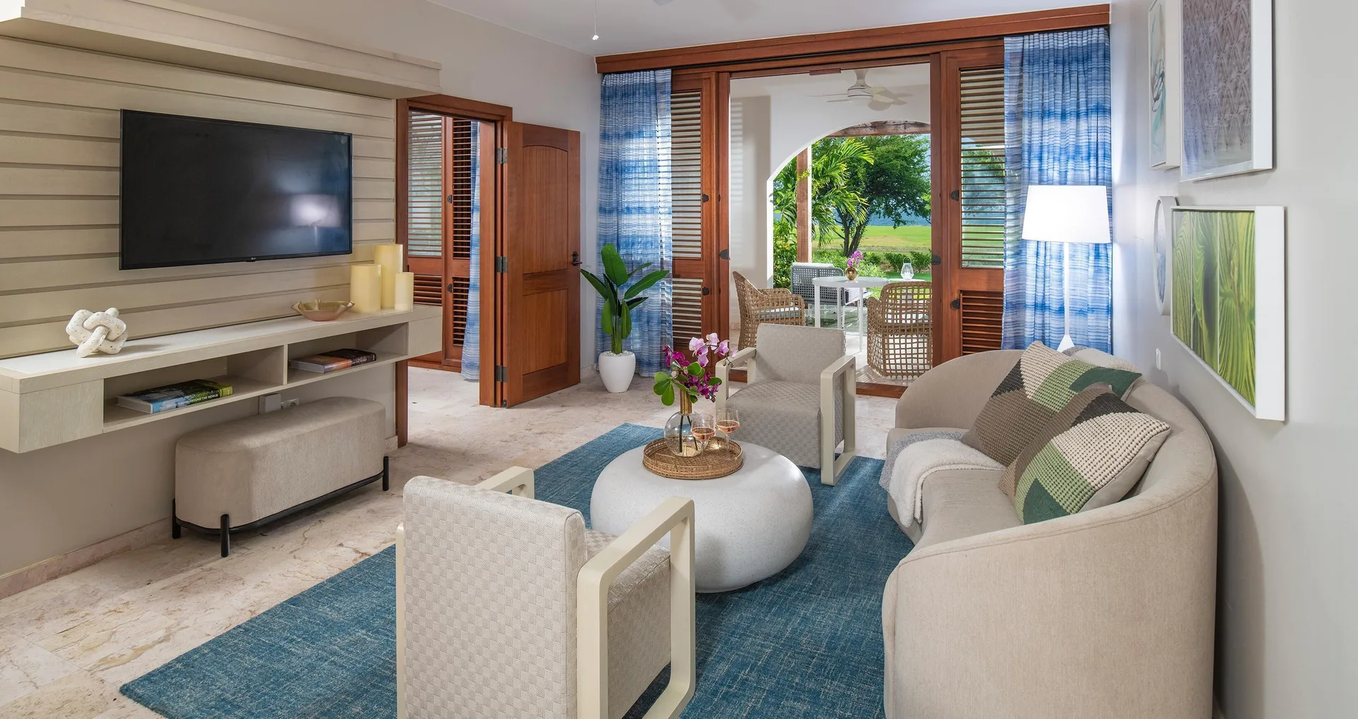 Cozy suite sitting area with patio doors at Sandals Royal Curacao.