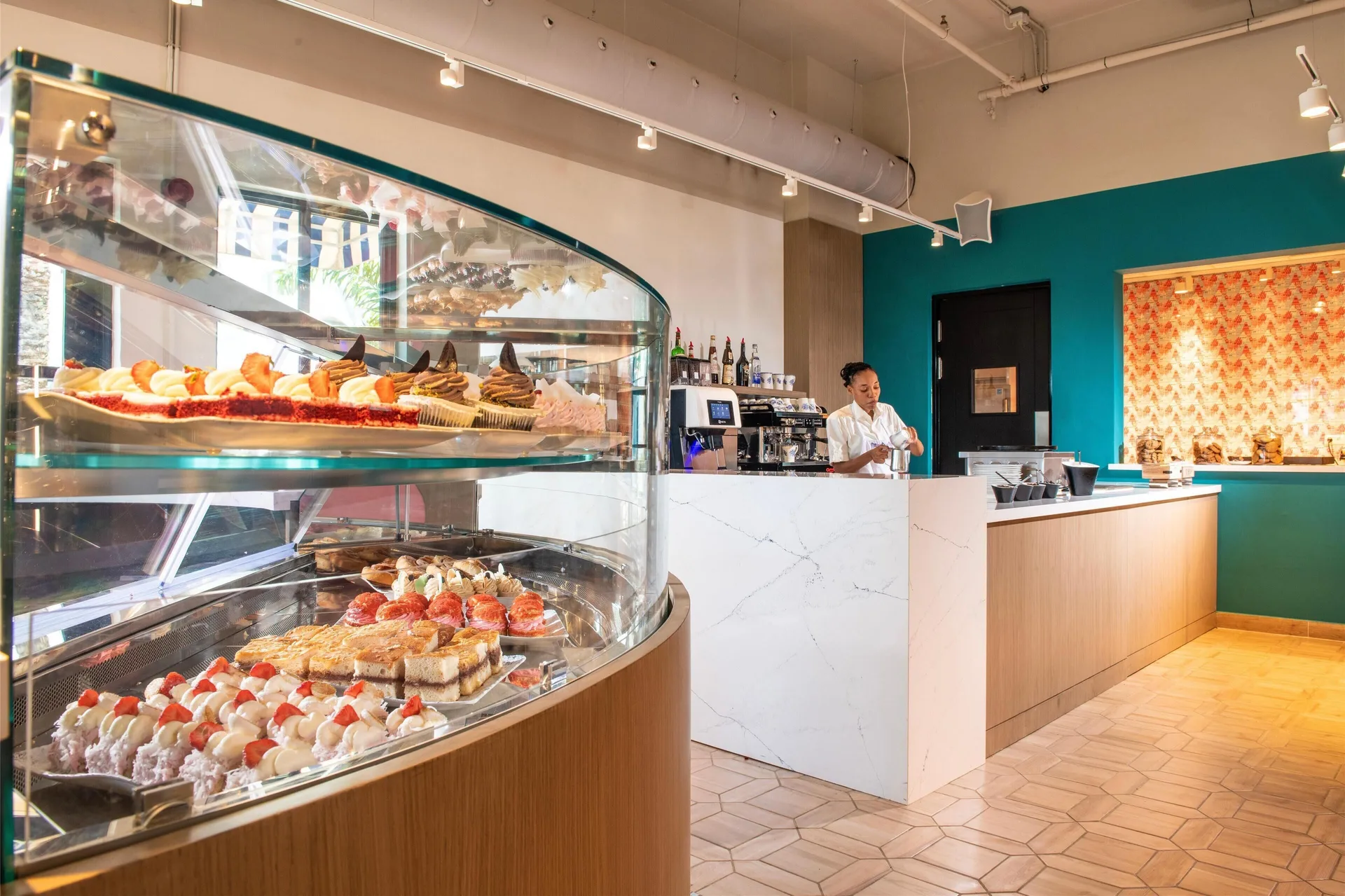 A cafe pastry case and counter inside Sandals Royal Curacao.