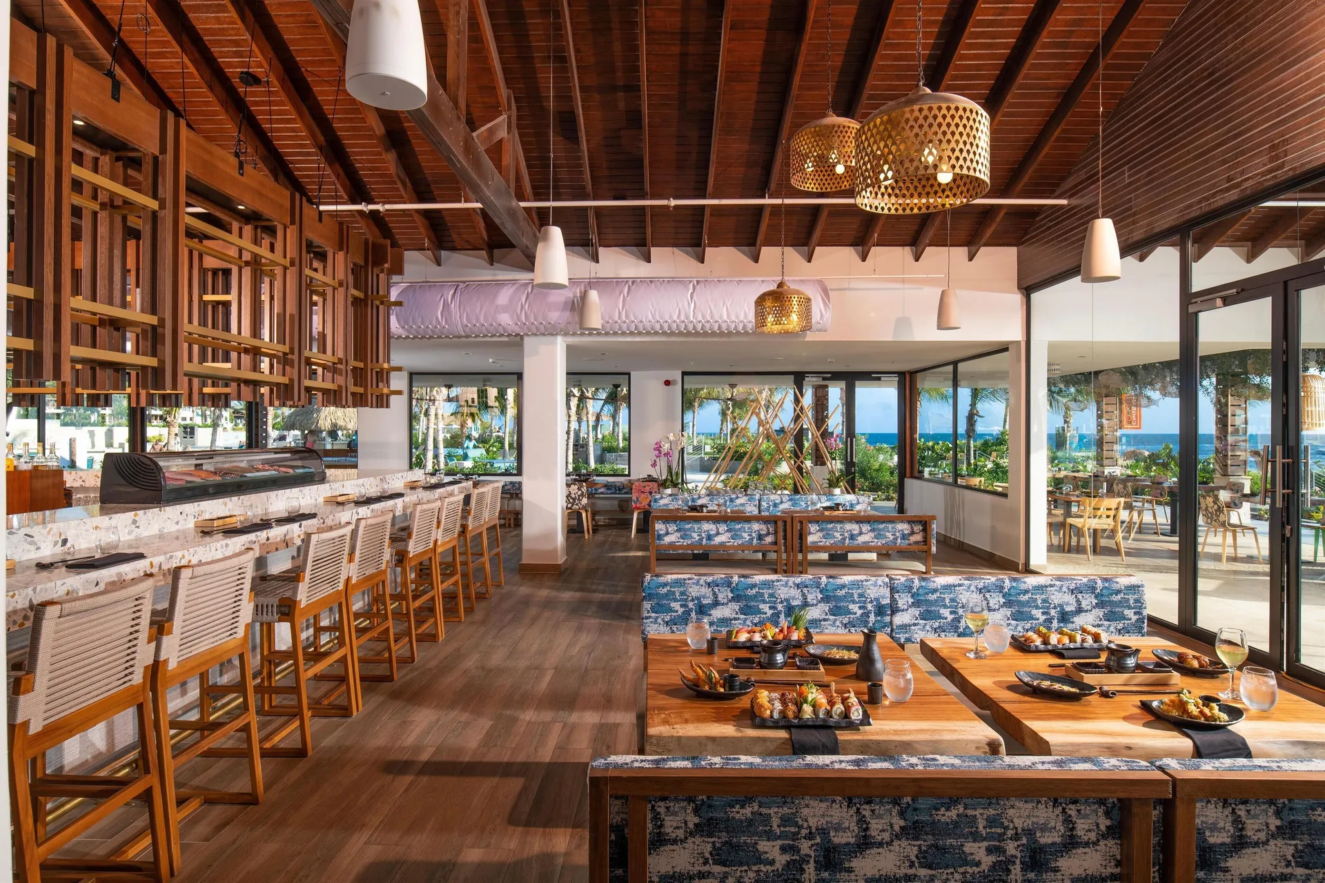 A sushi restaurant dining room with bar seating at Sandals Royal Curacao.