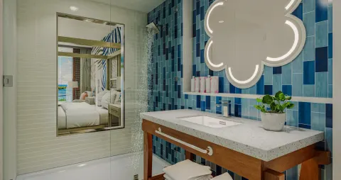Carisia Club Level Oceanview Room bathroom with blue tile shower at Sandals Royal Curacao.