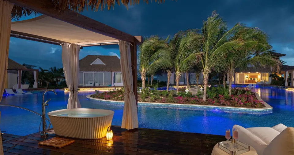 Evening patio with soaking tub overlooking the pool at Sandals Royal Curacao.