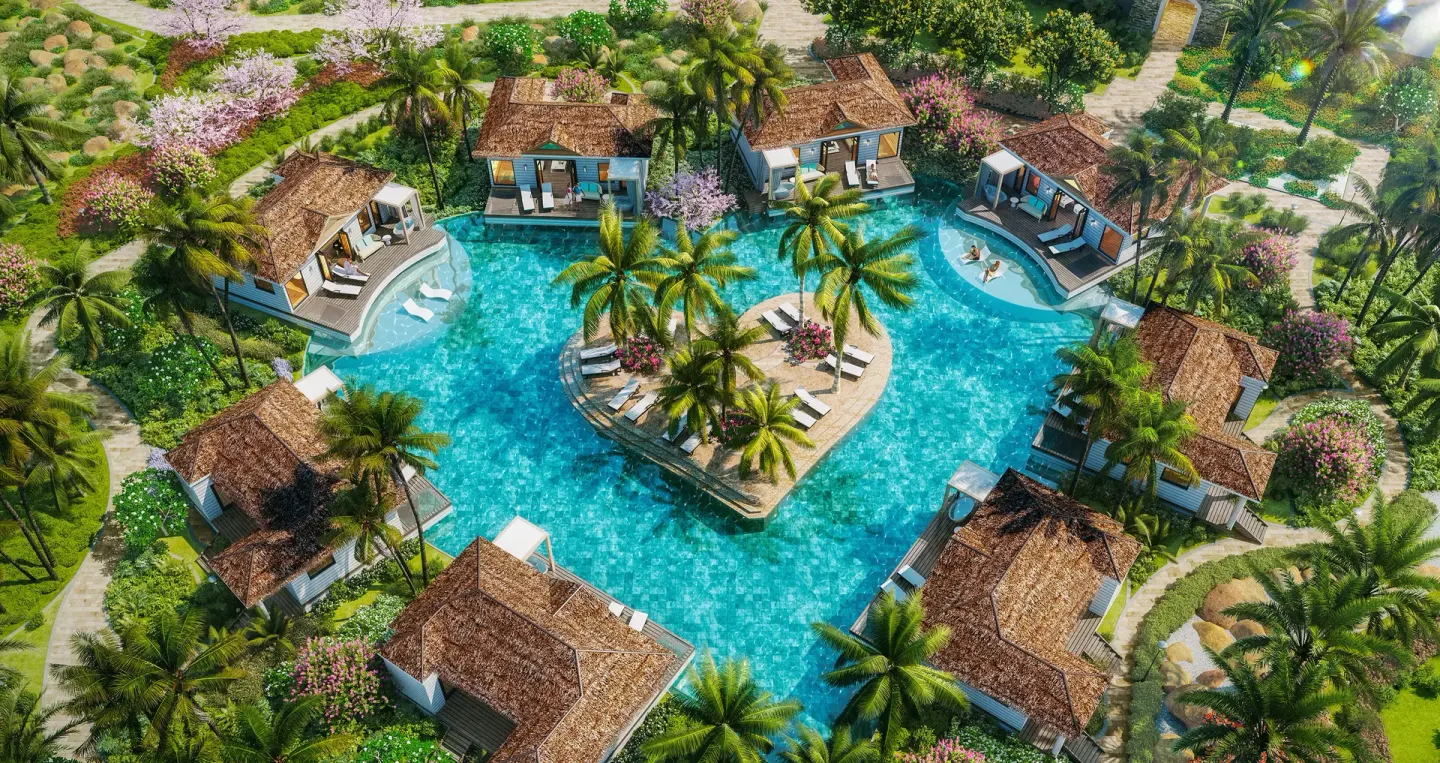 Aerial view of poolside bungalows around an island pool at Sandals Royal Curacao.