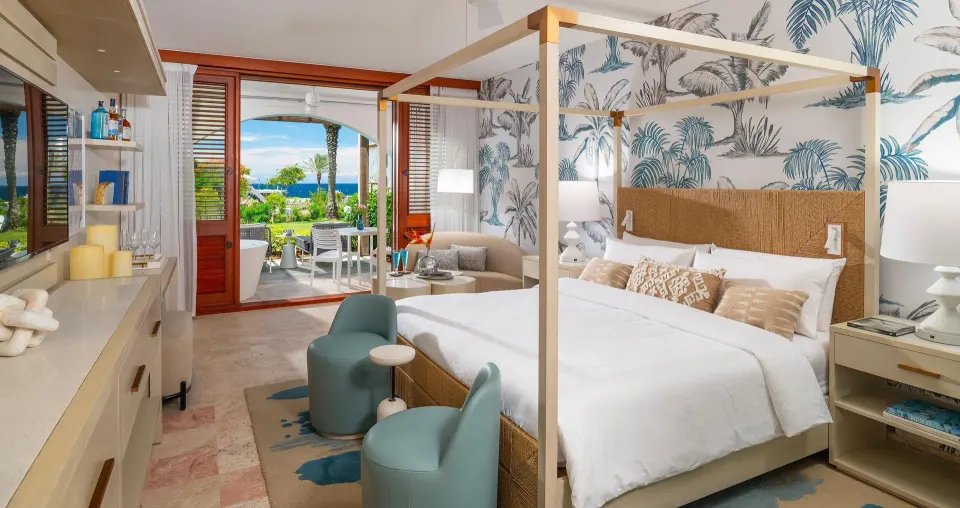 Subi Club Level walkout room with king bed and patio view at Sandals Royal Curacao.