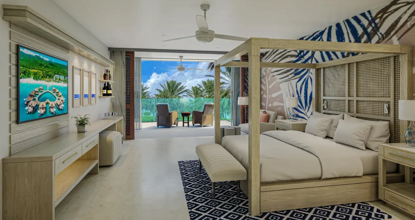 Subi Premium king room with patio seating at Sandals Royal Curacao.