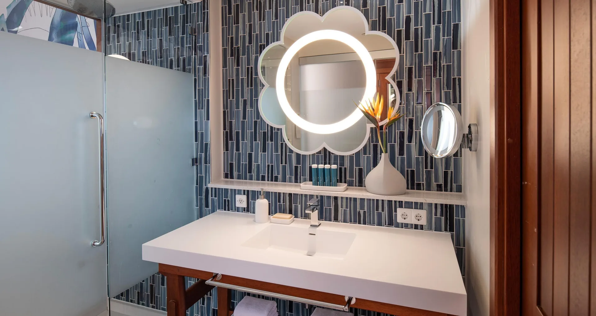 Bathroom vanity and glass shower in a Sunchi room at Sandals Royal Curacao.