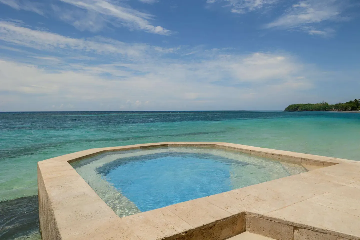 Oceanfront plunge pool overlooking turquoise water at Sandals Royal Plantation.