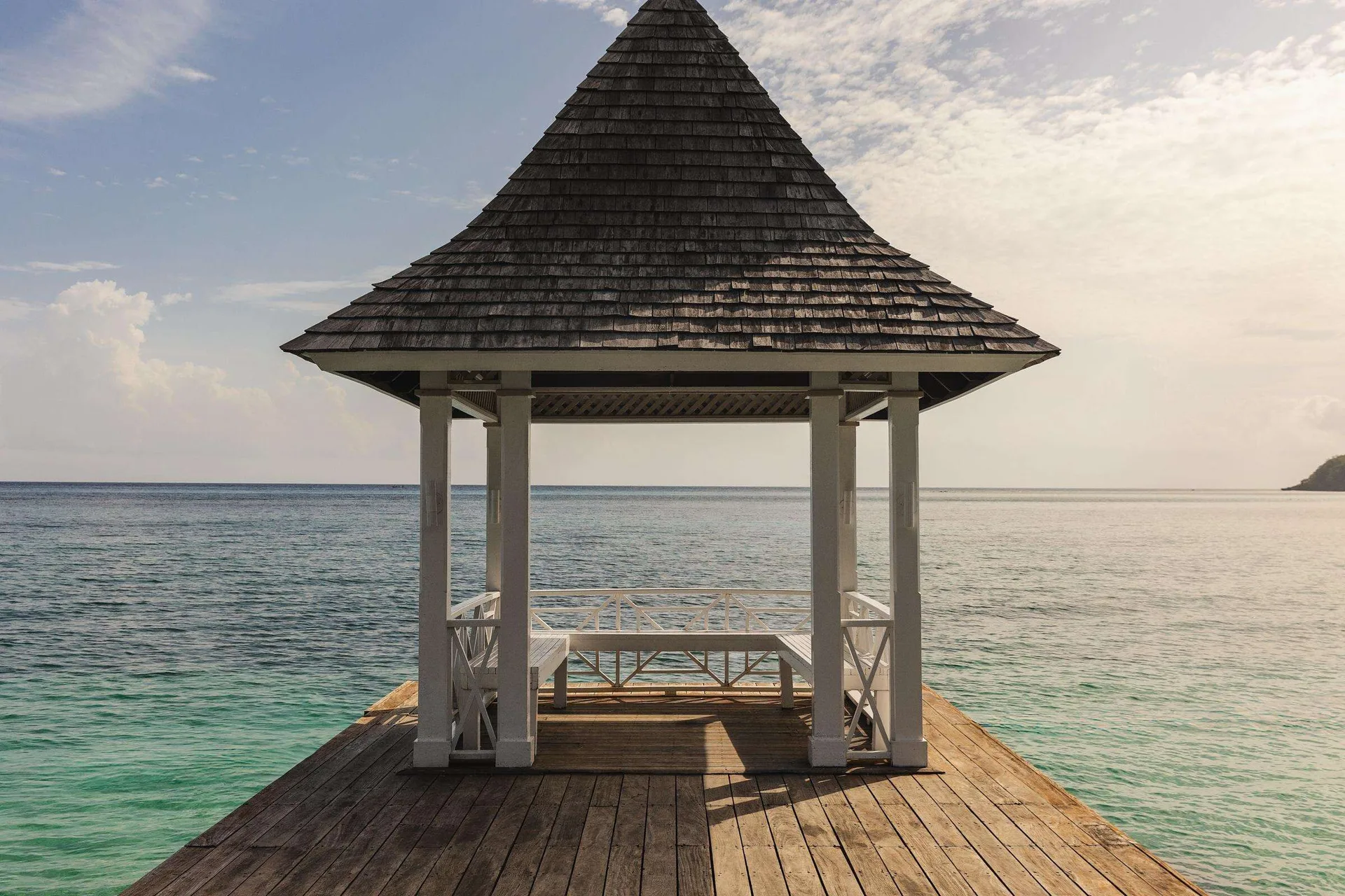 Overwater gazebo on a wooden pier at Sandals Royal Plantation.