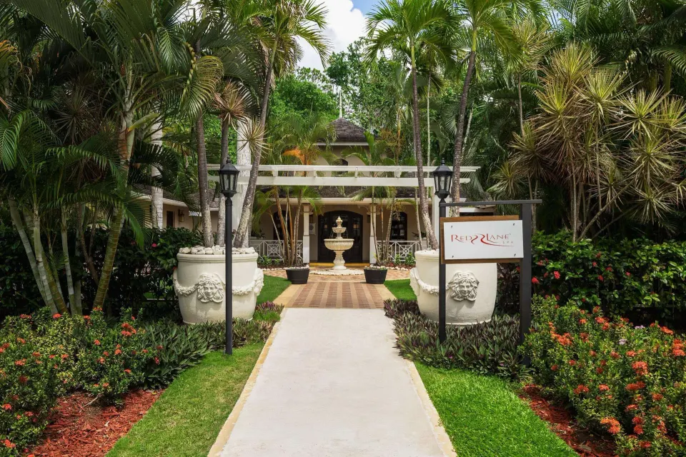 Red Lane Spa entrance path amid tropical gardens at Sandals Royal Plantation.
