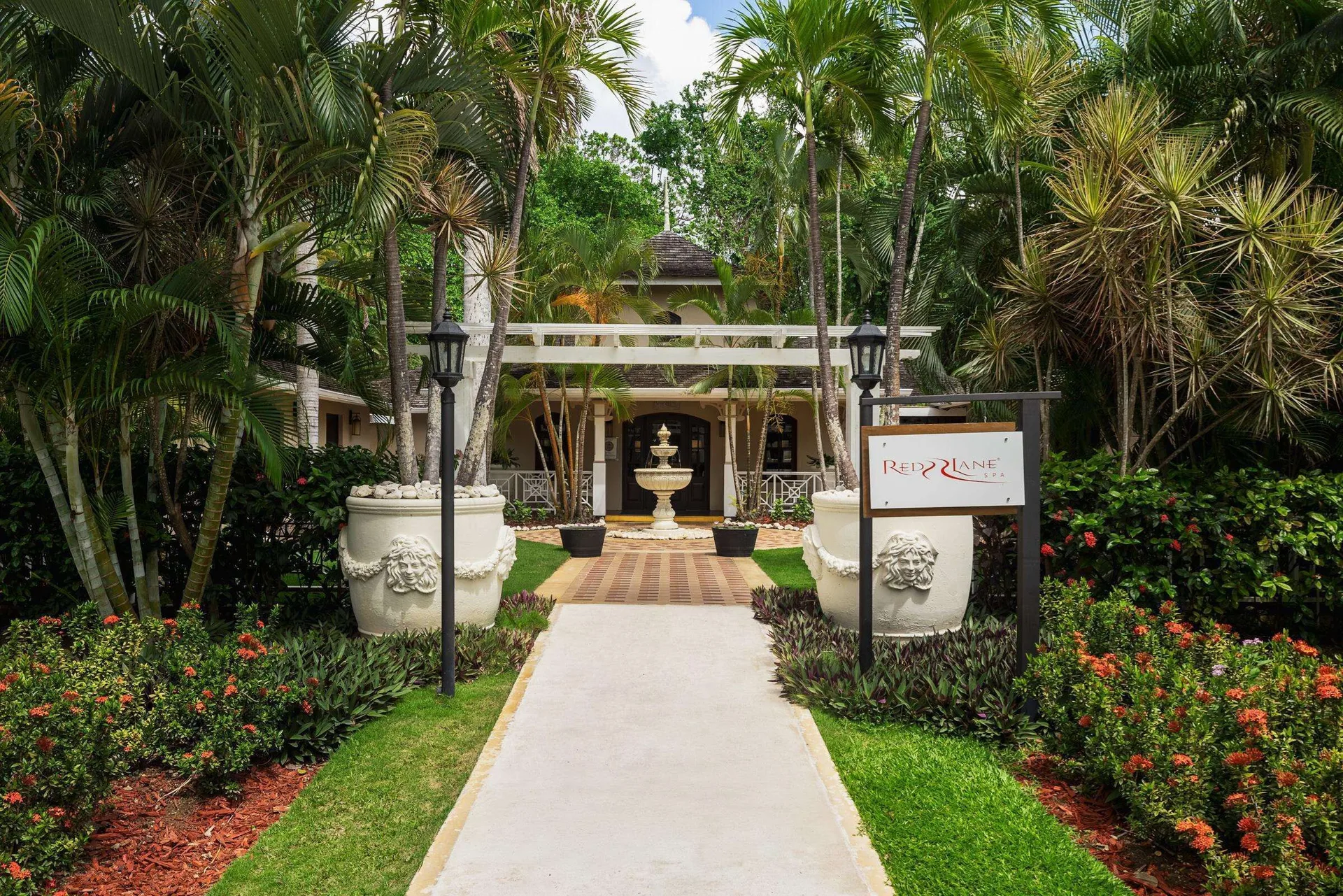 Red Lane Spa entrance path amid tropical gardens at Sandals Royal Plantation.