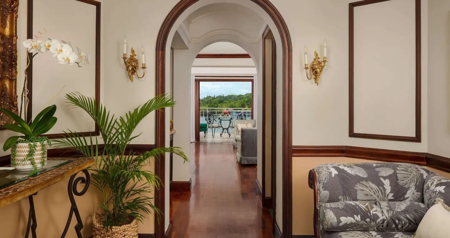 Arched suite hallway at Sandals Royal Plantation leading toward an oceanview balcony.