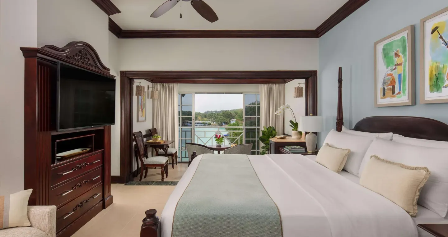 King bed and ocean-facing lounge in a Honeymoon Suite at Sandals Royal Plantation.