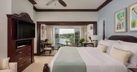 King bed and ocean-facing lounge in a Honeymoon Suite at Sandals Royal Plantation.