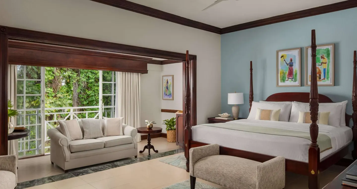 Ocean view one-bedroom suite with four-poster king bed at Sandals Royal Plantation.