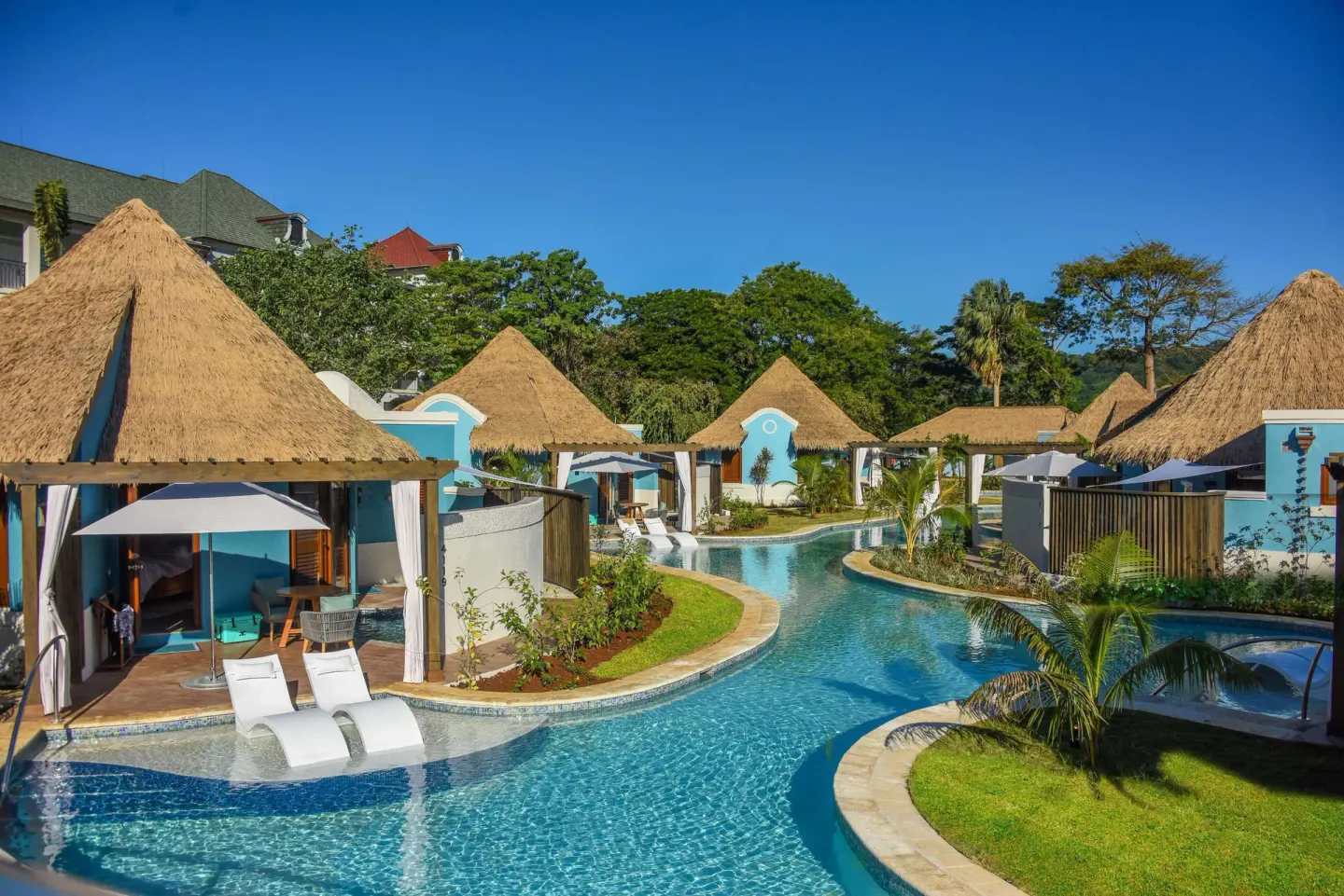 Swim-up rondoval suites and a winding pool at Sandals South Coast.
