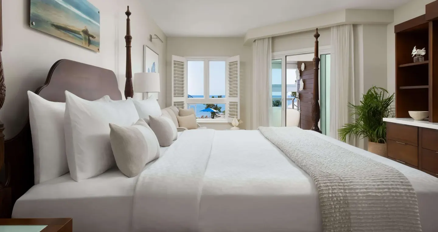Beachfront club room with four-poster king bed and ocean view at Sandals South Coast.